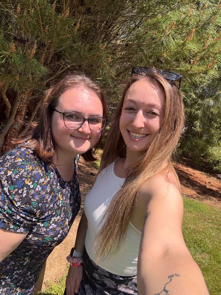 Justyna Fisler and Alyssa Goldman smiling together outdoors